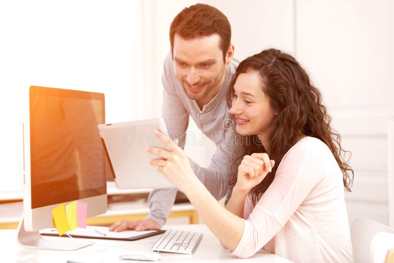 Man working with his co-worker on computer stock photos Man working with his co-worker on computer stock photos