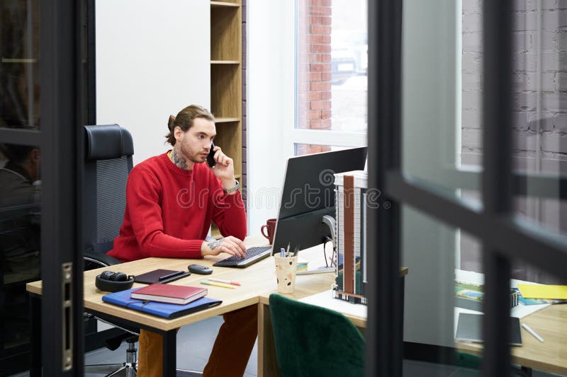 Man working at his workplace at office stock photo