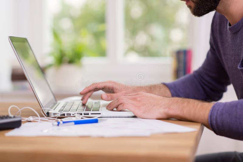 Man working from home on a laptop computer stock images