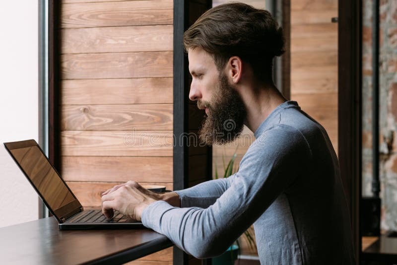 Man working laptop cafe freelance remote job