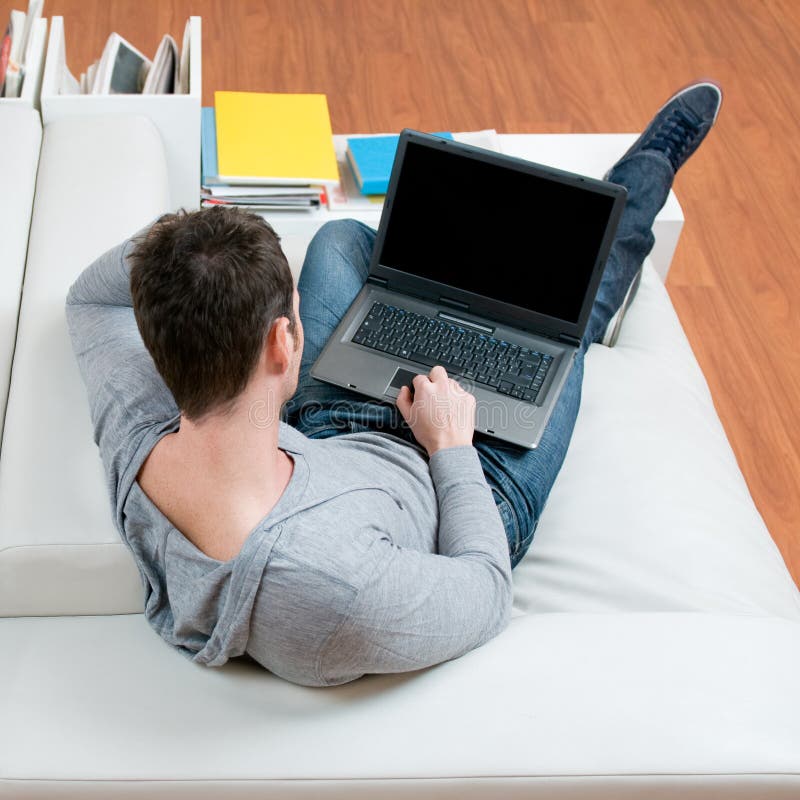 Man working on laptop at home stock photography