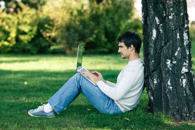 Man working with laptop outdoors