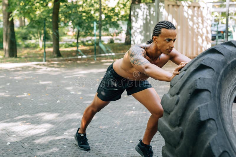 Man working out with heavy tire stock photography Man working out with heavy tire stock photography