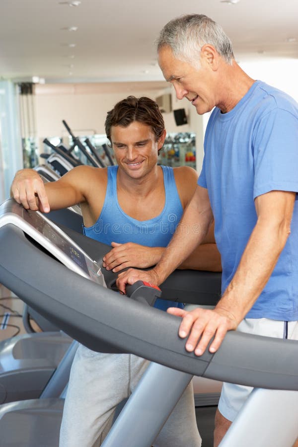 Man Working With Personal Trainer stock photography