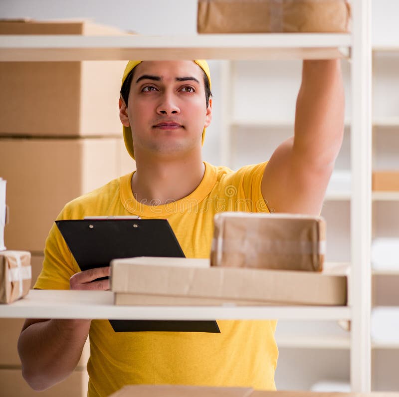 Man Working in Postal Parcel Delivery Service Office Stock Photo
