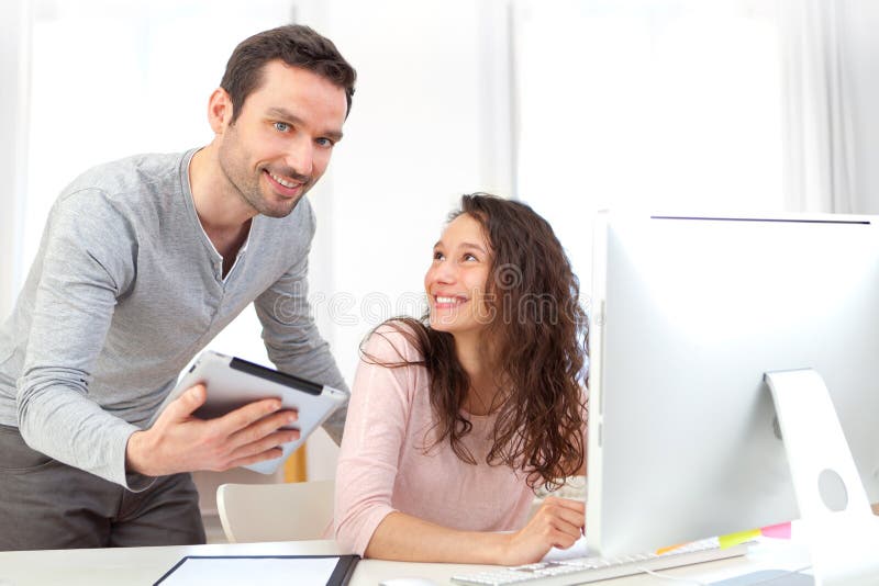 Man working on tablet with his co-worker stock photography Man working on tablet with his co-worker stock photography