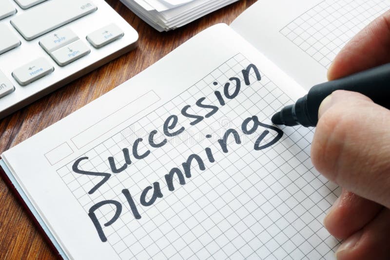 Man is writing succession planning. Man is writing succession planning in the book stock photography