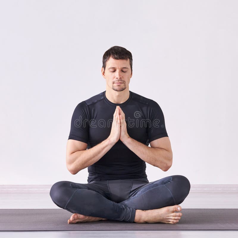 Man yoga class. Black wear. Calm relax pose