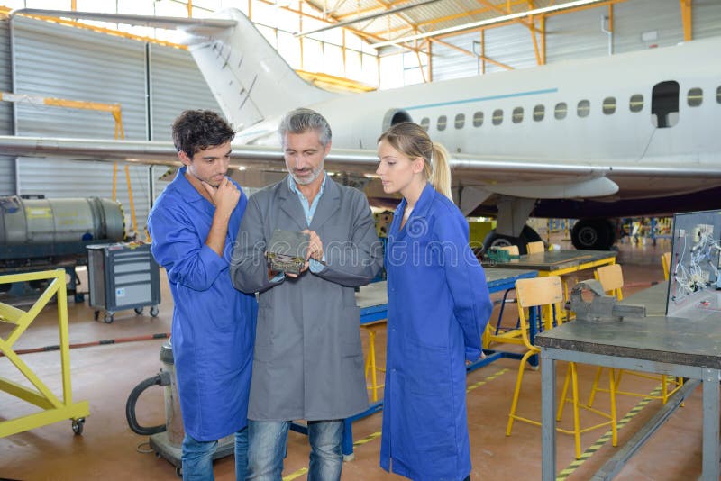 Man with young people in aircraft hangar royalty free stock photos Man with young people in aircraft hangar royalty free stock photos