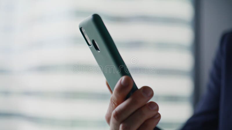 Manager hands holding smartphone reading message by office window closeup. stock video footage