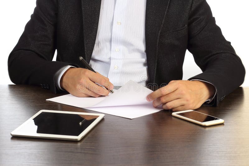 Manager at his desk signs papers isolated on white background. royalty free stock photography