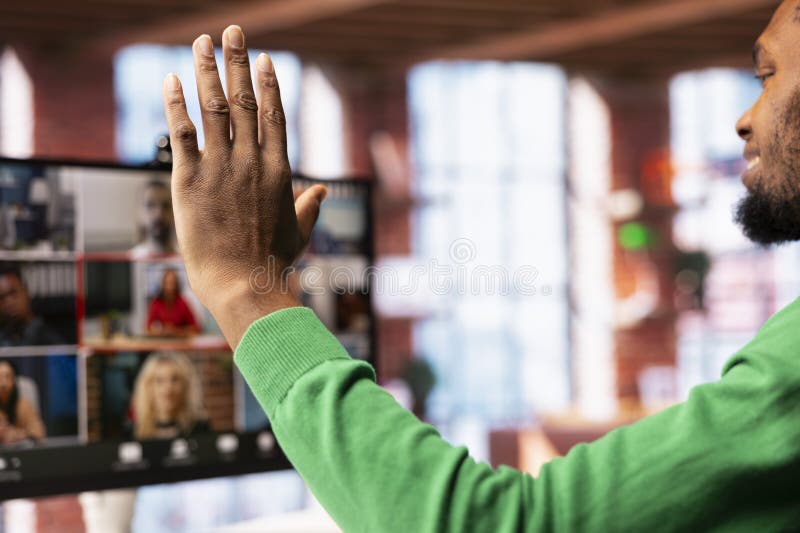 Team leader at home saluting teleworkers during remote videoconference meeting royalty free stock image