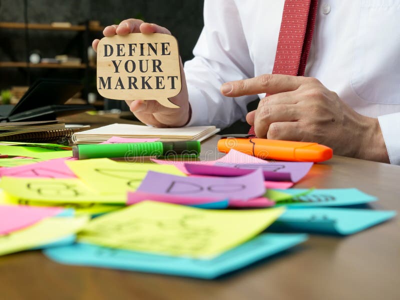 The Manager Points To the Sign with Define Your Market Words. Stock