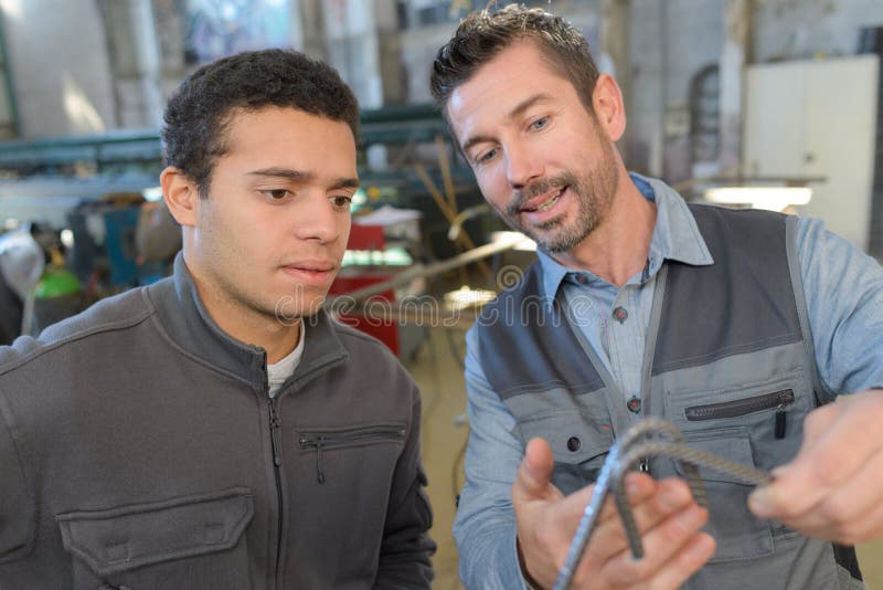 Manager showing assistant when to use piece metal stock image
