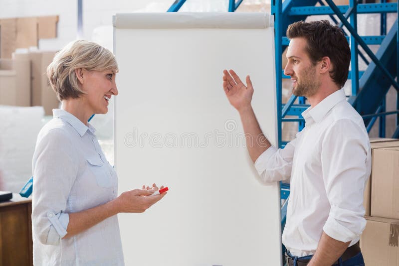Manager showing something to his colleague on whiteboard royalty free stock photos