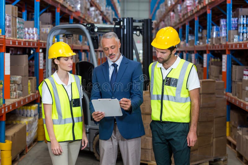 Manager showing tablet to workers stock photo