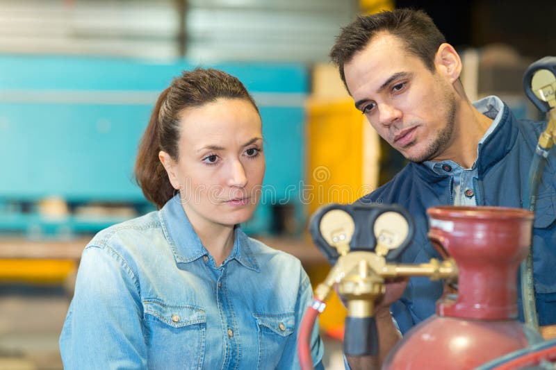 Manager showing task to worker in warehouse royalty free stock image