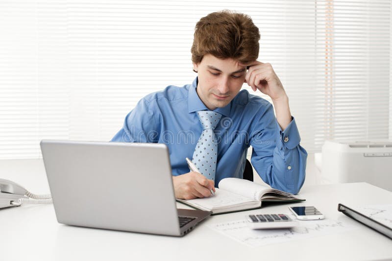 Manager sitting at desk in the office stock image