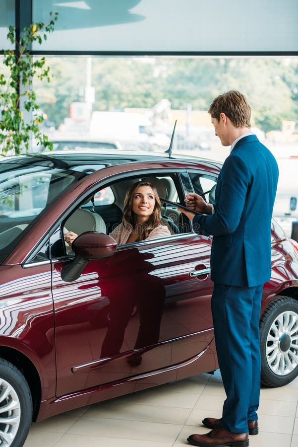 Manager Talking with a Beautiful Customer after Testdriving a Stock