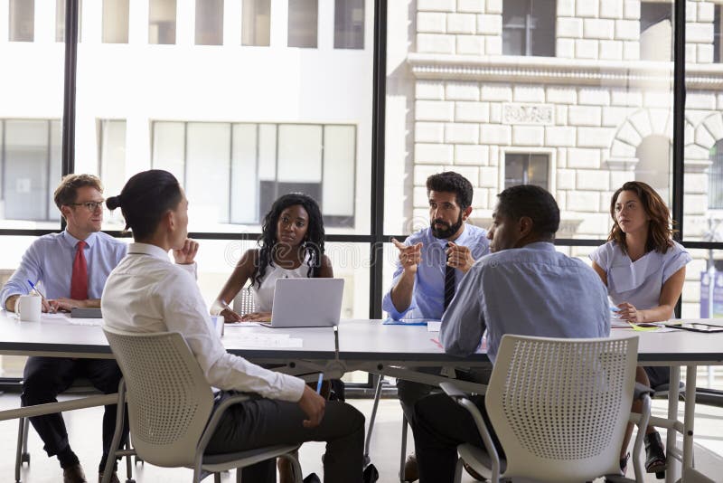 Manager talks to business colleagues at a meeting, close up