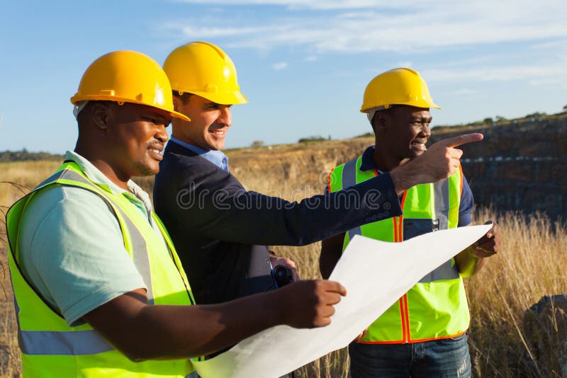 Mine manager and workers at quarry discussing future plan. Mine manager and workers at quarry discussing future plan