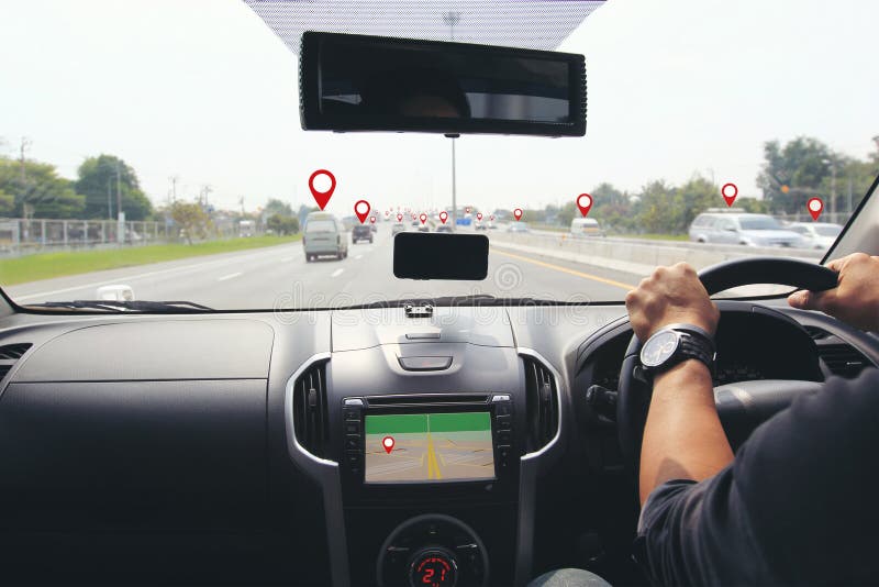 Man driver hands holding the car steering panel with map gps navigation inside car and pins or gps map on vehicles on the highway. Man driver hands holding the car steering panel with map gps navigation inside car and pins or gps map on vehicles on the highway.