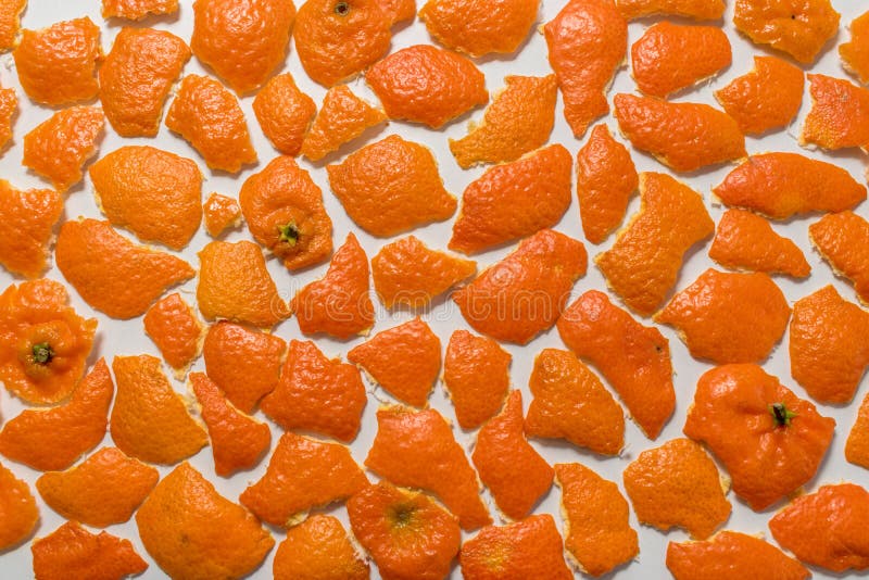 Mandarin peels on white background. Top view.