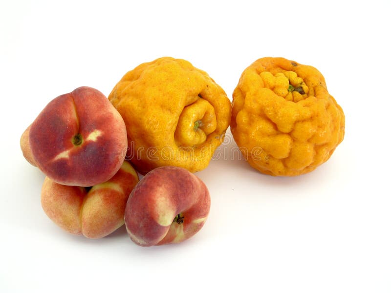 A couple ugly tangerines and a few donut peaches. A couple ugly tangerines and a few donut peaches
