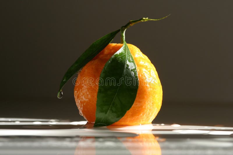 Mandarin on the table, dark background,light. Mandarin on the table, dark background,light