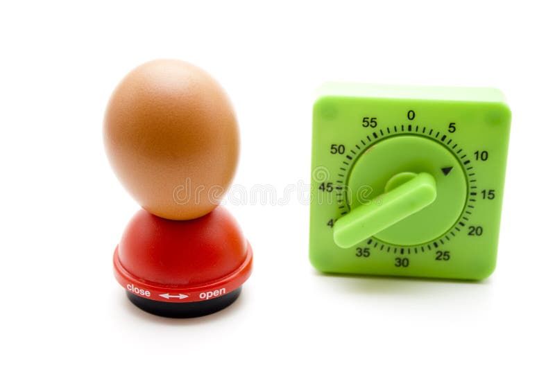 Eggs mandrel with egg and time Scolding clock on white background. Eggs mandrel with egg and time Scolding clock on white background