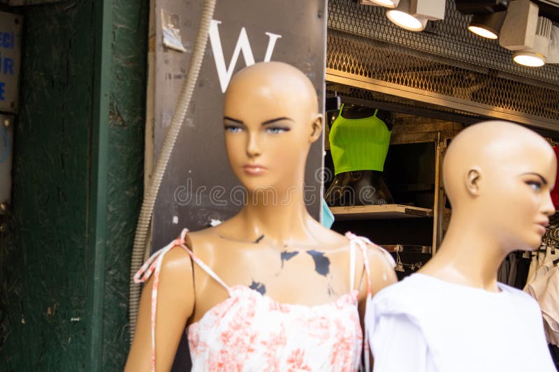 2 bold female Mannequins in the entrance of clothes shop. 2 bold female Mannequins in the entrance of clothes shop