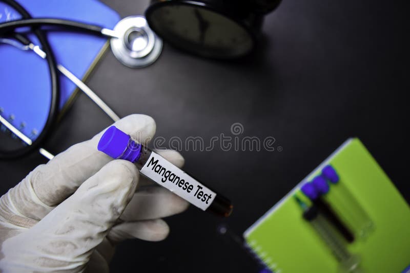 Manganese Test text with blood sample. Top view isolated on black background. Healthcare/Medical concept stock photography Manganese Test text with blood sample. Top view isolated on black background. Healthcare/Medical concept stock photography