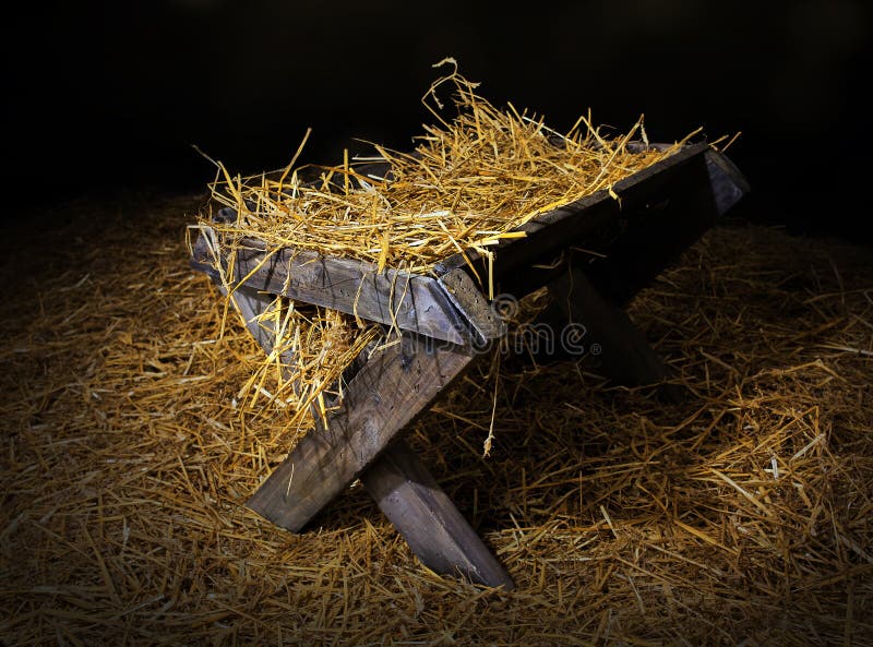 Manger with straw. An old manger filled with straw stock image