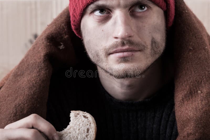 Mangeur d'hommes sans abri un morceau de pain photographie stock libre de droits Mangeur d'hommes sans abri un morceau de pain photographie stock libre de droits