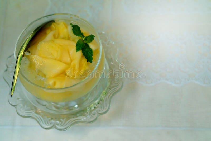 Mango compote or Mango in syrup is Thai dessert make by slide mango soak cool syrup with white background.Make fulfill in Thailand summer time.have some space for write wording