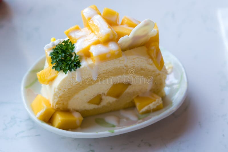 Mango Cream Roll Cake with Mango Dices Topping. Stock Photo Image of