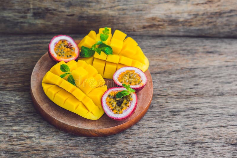 Mango and passion fruit on an old wooden background