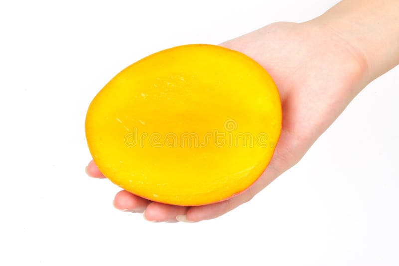 Mango slice in hand royalty free stock photography