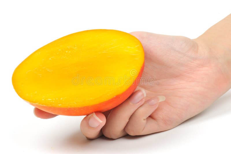 Mango slice in hand royalty free stock photos