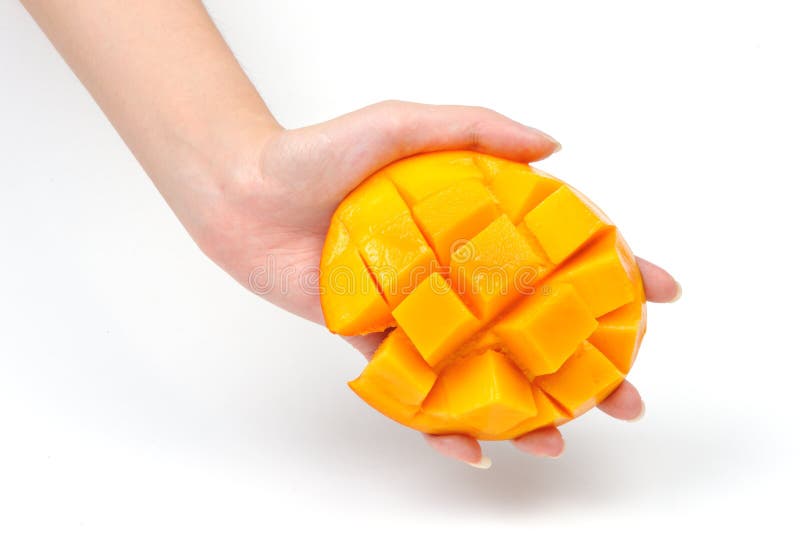 Mango slice in hand royalty free stock photography