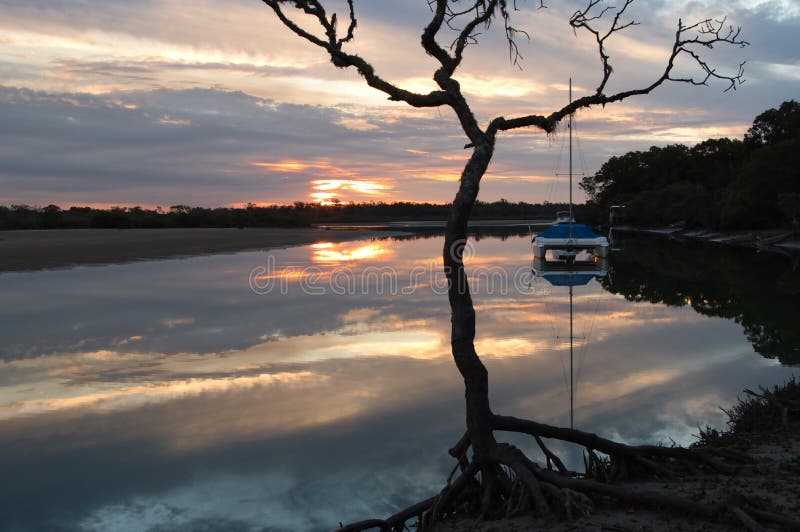 Reflections of Yacht and Mangrove silhouette  in Winter Sunset Beelbi Creek