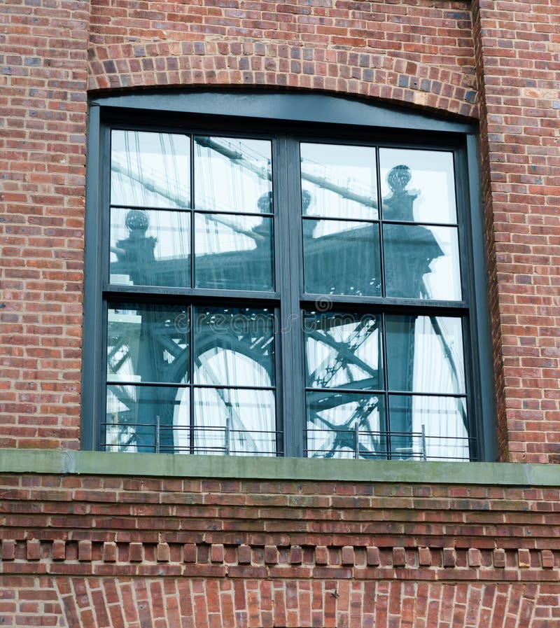 Manhattan Bridge Reflected in Brick Building Window.