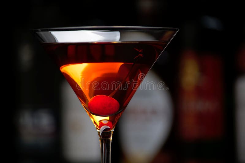 Manhattan Drink with Cherry with Bar in the Background Stock Photo