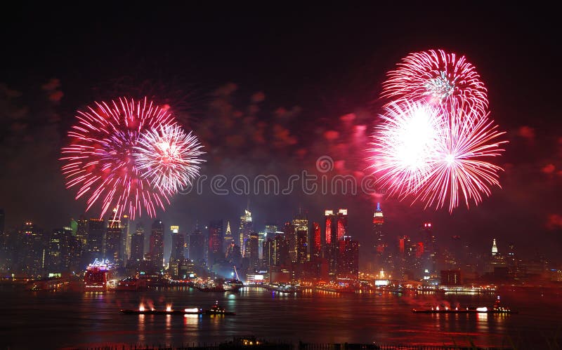 New York City Manhattan July 4th Independence day fireworks show with skyline over Hudson River viewed from New Jersey. New York City Manhattan July 4th Independence day fireworks show with skyline over Hudson River viewed from New Jersey