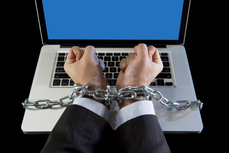 Hands of caucasian businessman addicted to work tied and bond with iron chain handcuffed to computer laptop in workaholic, internet slave and addict concept. Hands of caucasian businessman addicted to work tied and bond with iron chain handcuffed to computer laptop in workaholic, internet slave and addict concept