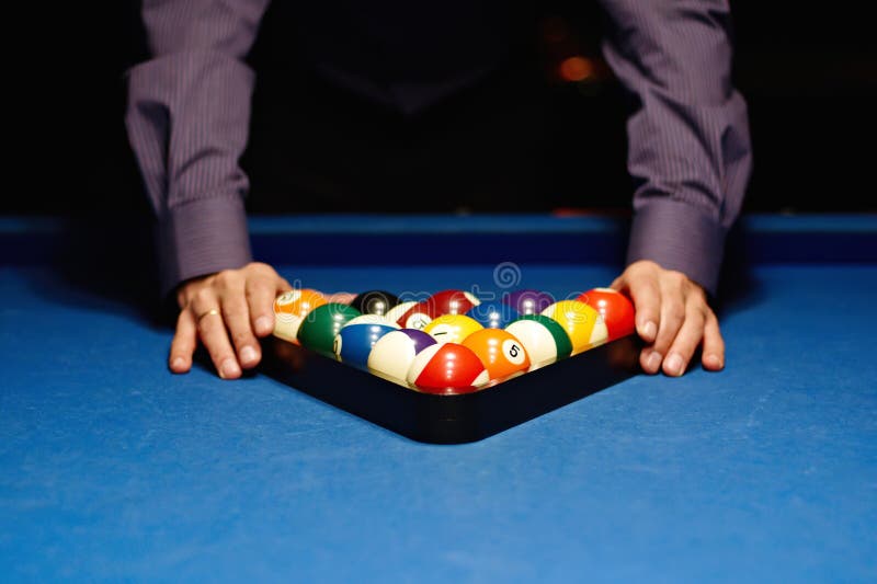 Man places billiard balls on the table. Man places billiard balls on the table