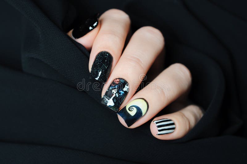 Black nail art Halloween manicure in the style of nightmare before Christmas with skull and spiderweb. Black nail art Halloween manicure in the style of nightmare before Christmas with skull and spiderweb