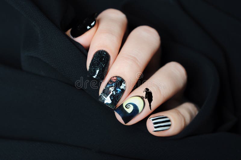 Black nail art Halloween manicure in the style of nightmare before Christmas with skull, cobwebs and crow. Black nail art Halloween manicure in the style of nightmare before Christmas with skull, cobwebs and crow
