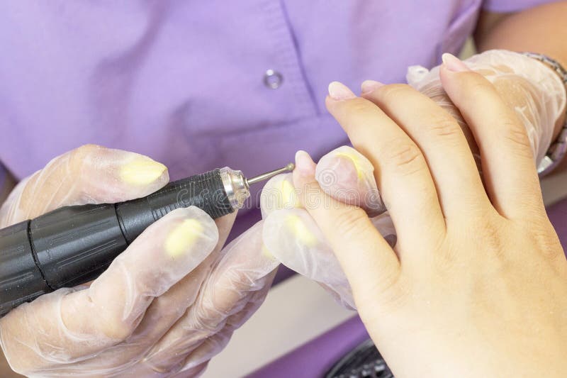 Manicure. the manicurist polishes and processes nails to the client. hardware manicure. result royalty free stock image Manicure. the manicurist polishes and processes nails to the client. hardware manicure. result royalty free stock image