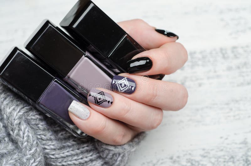 manicure in Scandinavian style in black white gray and purple color triangle pattern